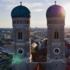 The towers of the Frauenkirche in Munich taken against the sun from the air with a drone