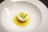 A dessert with pineapple on a white plate in the star restaurant Atelier in the Hotel Bayerischer Hof in Munich