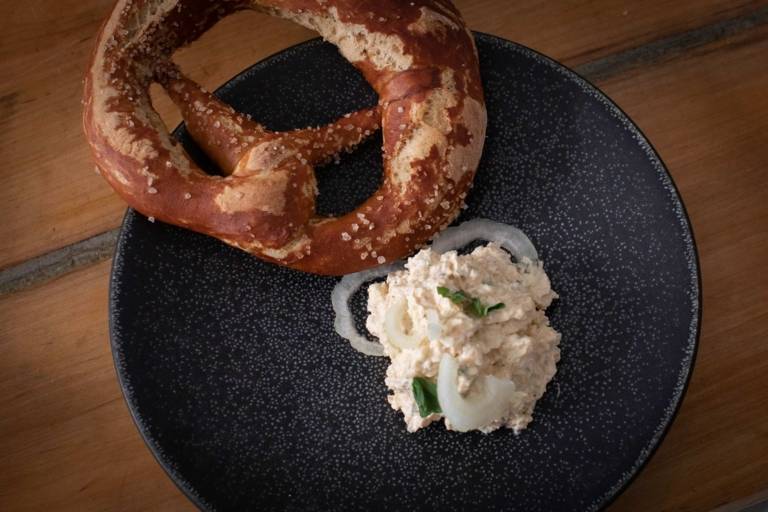 A plate with homemade pretzel and fresh Bavarian cream cheese.