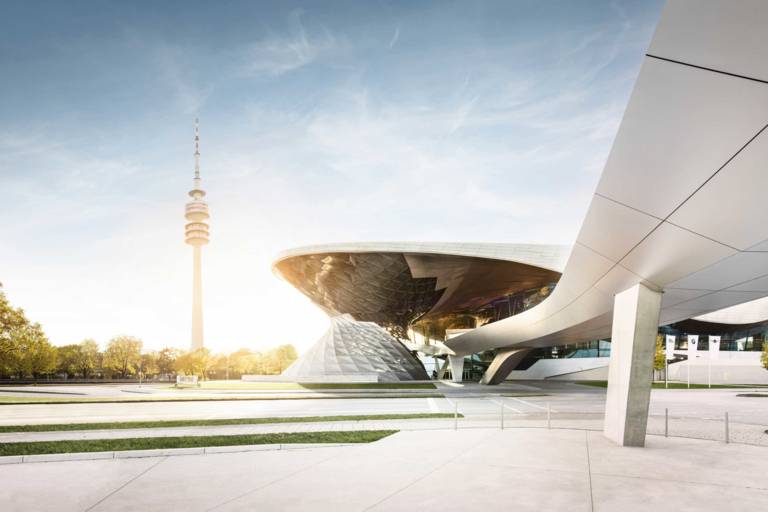 The double helix of BMW Welt in Munich with the Olympic Tower in the background
