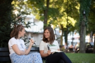 Two young women in conversation with microphones in Munich.
