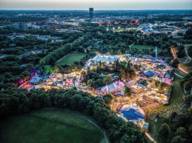 The Munich Summer Tollwood Festival in the Olympiapark photographed from above with a drone at nightfall.