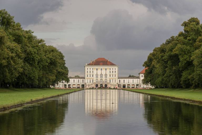 The Nymphenburg Palace Canal and Nymphenburg Palace against a cloudy sky