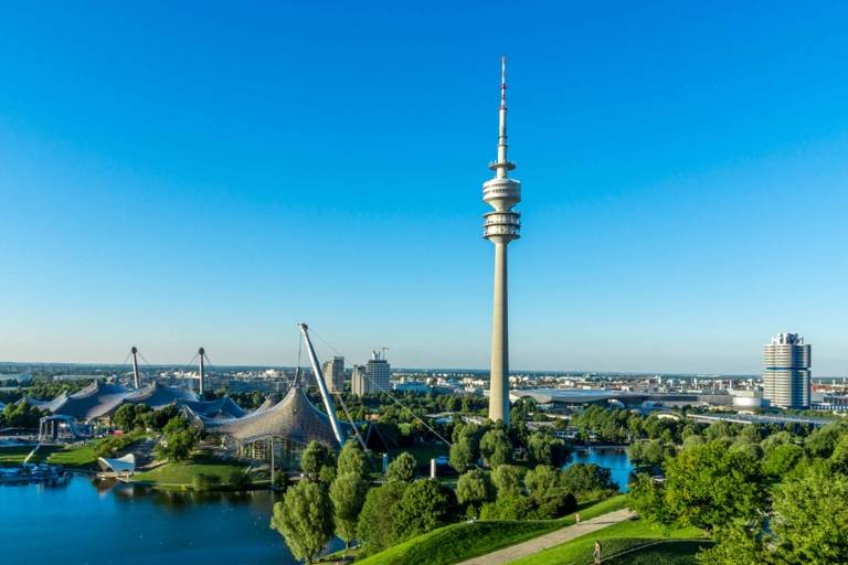Panoramic view from the Olympiaberg with Olympic Lake, Olympic Tower and the headquarter of BMW in Munich in the background.